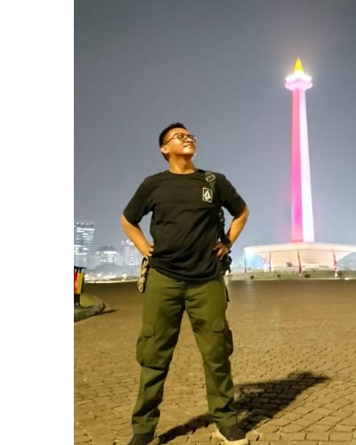 Full-body shot of the developer working at a computer in a modern office environment