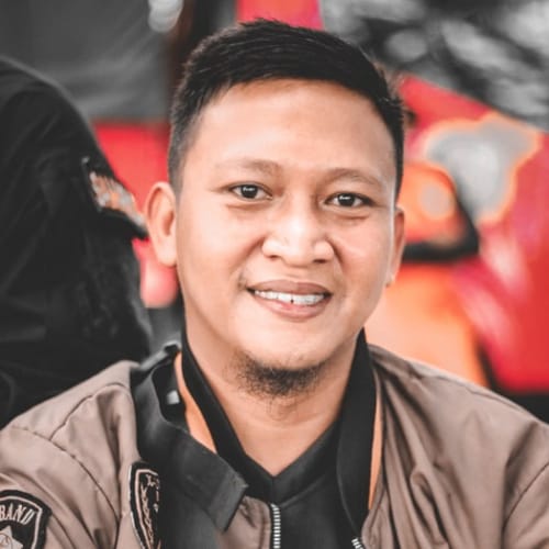 Professional headshot of a smiling web developer in a business casual outfit